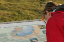 06-5129 Female Walker Reading Information Board About Moor House Nature Reserve, Upper Teesdale, County Durham.